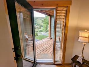 a door to a balcony with a view of a deck at Tenderfoot Lodge 2613 by SummitCove Lodging in Colorado in Keystone