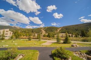 a view of a park with mountains in the background at Tenderfoot Lodge 2613 by SummitCove Lodging in Colorado in Keystone