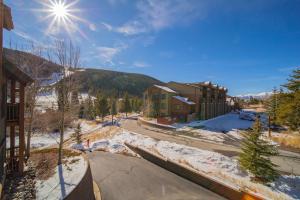 a snow covered street in a town with a mountain at Tenderfoot Lodge 2620 by SummitCove Lodging in Colorado in Keystone