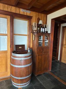 a wine barrel with a laptop on top of it at Ushuaia Lodge in Ushuaia +43 photos