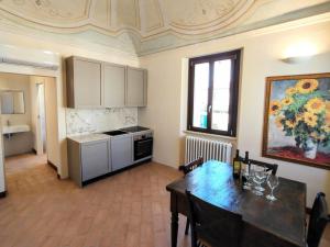 a kitchen with a table and a dining room at Apartment Monsignore, Pesaro in Pesaro