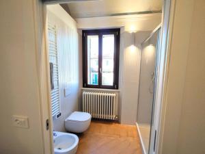 a bathroom with a toilet and a sink and a window at Apartment Monsignore, Pesaro in Pesaro +32 photos