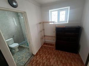 a bathroom with a toilet and a shower and a window at Happy house in Kobuleti +18 photos