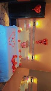 a room with a bed with decorations on the wall at Sunrise Lodging in Douala