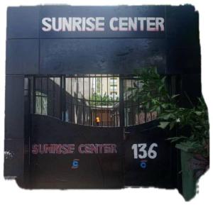 a building with a sunrise center sign in front of it at Sunrise Lodging in Douala