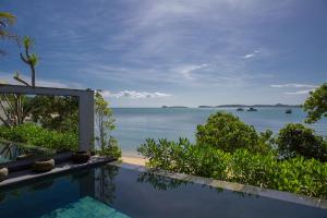 a swimming pool with a view of the ocean at Clay Beach Samui - Beachfront Villas in Bophut +95 photos