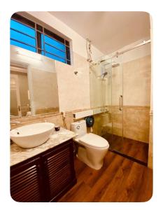 a bathroom with a toilet and a sink and a shower at Rose's House Hue in Hue +21 photos