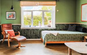 a bedroom with a bed and a window and a chair at Cozy Apartment In Outrup With Wifi in Ovtrup