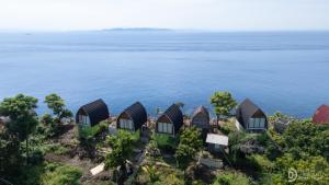 an aerial view of a row of houses next to the water at Eco-tourist Dream Beach Cliff Villas in Nusa Penida