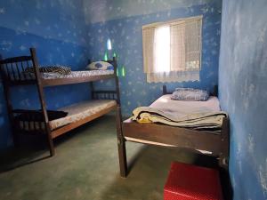 a room with two bunk beds and a window at Vila Druida Spa Caipira in São Thomé das Letras +12 photos