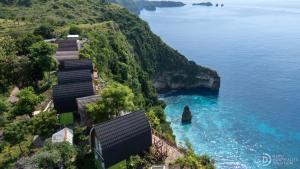 a view of the ocean from a hill with houses at Eco-tourist Dream Beach Cliff Villas in Nusa Penida