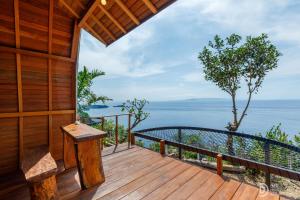 a wooden deck with a view of the ocean at Eco-tourist Dream Beach Cliff Villas in Nusa Penida