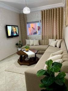 a living room with a couch and a table at Cozy apartment center, Larache in Larache