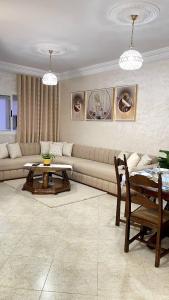 a living room with a couch and a table at Cozy apartment center, Larache in Larache