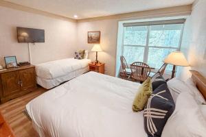 a hotel room with two beds and a window at So Davis St 333 Unit #414 ~ Mountaineer in Telluride