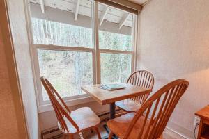 a table and chairs in a room with a window at So Davis St 333 Unit #414 ~ Mountaineer in Telluride