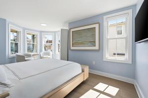 a bedroom with a bed and two windows at The Marilyn Inn in Ocean Grove +5 photos