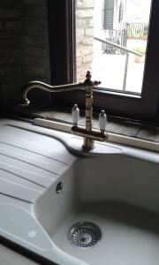 a sink with a faucet in front of a window at Residenza Sant'Antonio in Deliceto