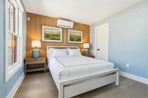 a bedroom with a white bed and a window at The Marilyn Inn in Ocean Grove