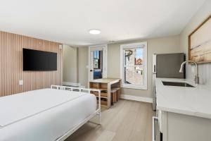 a hospital room with a bed and a sink at The Marilyn Inn in Ocean Grove