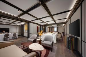 a room with a long table and chairs and a television at Haig Court - Welcome Drink & Welcome Fruit in Shanghai