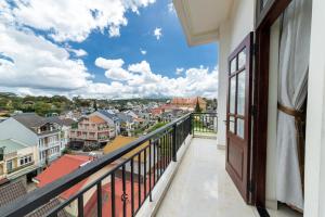 a balcony with a view of a city at Xuan Truong Central Dalat-1 min walk to Xuan Huong Lake in Da Lat