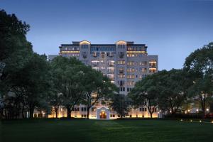 a large building with a park in front of it at Haig Court - Welcome Drink & Welcome Fruit in Shanghai
