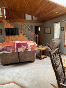 a bedroom with a large bed and a staircase at Woodland Hideaway in Naples