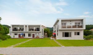 a large white house with a large yard at Chuncheon Venue Pool Villa August 19 in Chuncheon