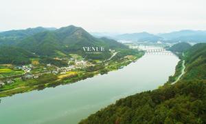 an aerial view of a river with a bridge at Chuncheon Venue Pool Villa August 19 in Chuncheon +4 photos