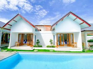 a house with a swimming pool in front of it at Casa de Ambalia in Uluwatu