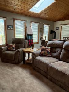 a living room with a couch and a table at Woodland Hideaway in Naples