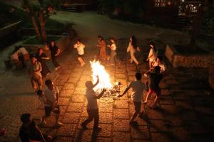 a group of people standing around a fire at ANOR Farmstay - Two Double Bed in Hue