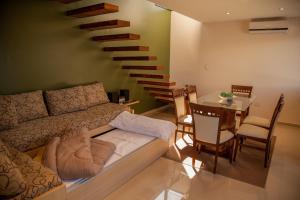 a living room with a couch and a staircase at Lake Point Residencias in Villa Parque Siquiman