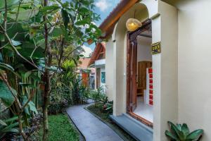 a door to a house with a garden at Ubud Mesari Private Pool Villa in Ubud