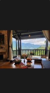a dining room table with a view of a balcony at Joy Villa Sapa in Sapa