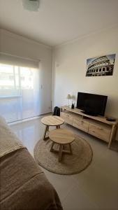 a living room with a couch and a table and a tv at Rondine Federación in Federación