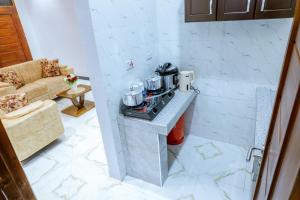 a kitchen with a counter with pots and pans on it at Cozycore Apartment in Dodoma