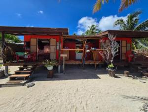 a house on the beach with a sandy beach at Tikehau Herearii in Tikehau Airport