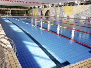 a large swimming pool in a large building at Wanshang Garden Hotel in Beijing