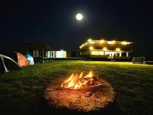 a fire in front of a building at night at Nara Hills in Sembalun Lawang