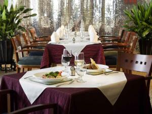 a table with plates of food and wine glasses at Wanshang Garden Hotel in Beijing