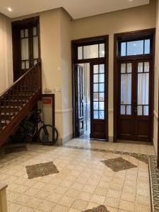 a hallway with doors and a staircase in a house at Casa Boedo in Buenos Aires