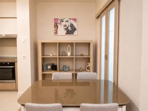 a dining room with a glass table and two chairs at Urban Temple Apartment near Cathedral Free Parking in Podgorica