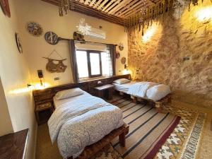 a bedroom with two beds and a window at Carob Hostel in Amman
