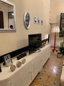 a living room with a dresser with a television on it at Casa Boedo in Buenos Aires +46 photos