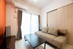 a living room with a couch and a table at SPAZIO 4 Tenjin Minami in Fukuoka