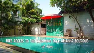 a sign on the side of a house with a red umbrella at AHHA Bungalow Kampot in Kampot