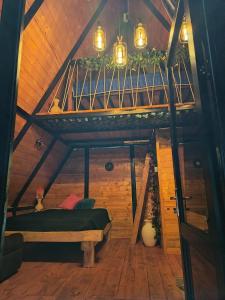 an attic room with a bed and a wooden ceiling at Glamping Jadiva in Cucunubá