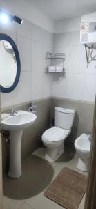 a bathroom with a toilet and a sink and a mirror at Monoambiente como en casa in Montevideo +14 photos